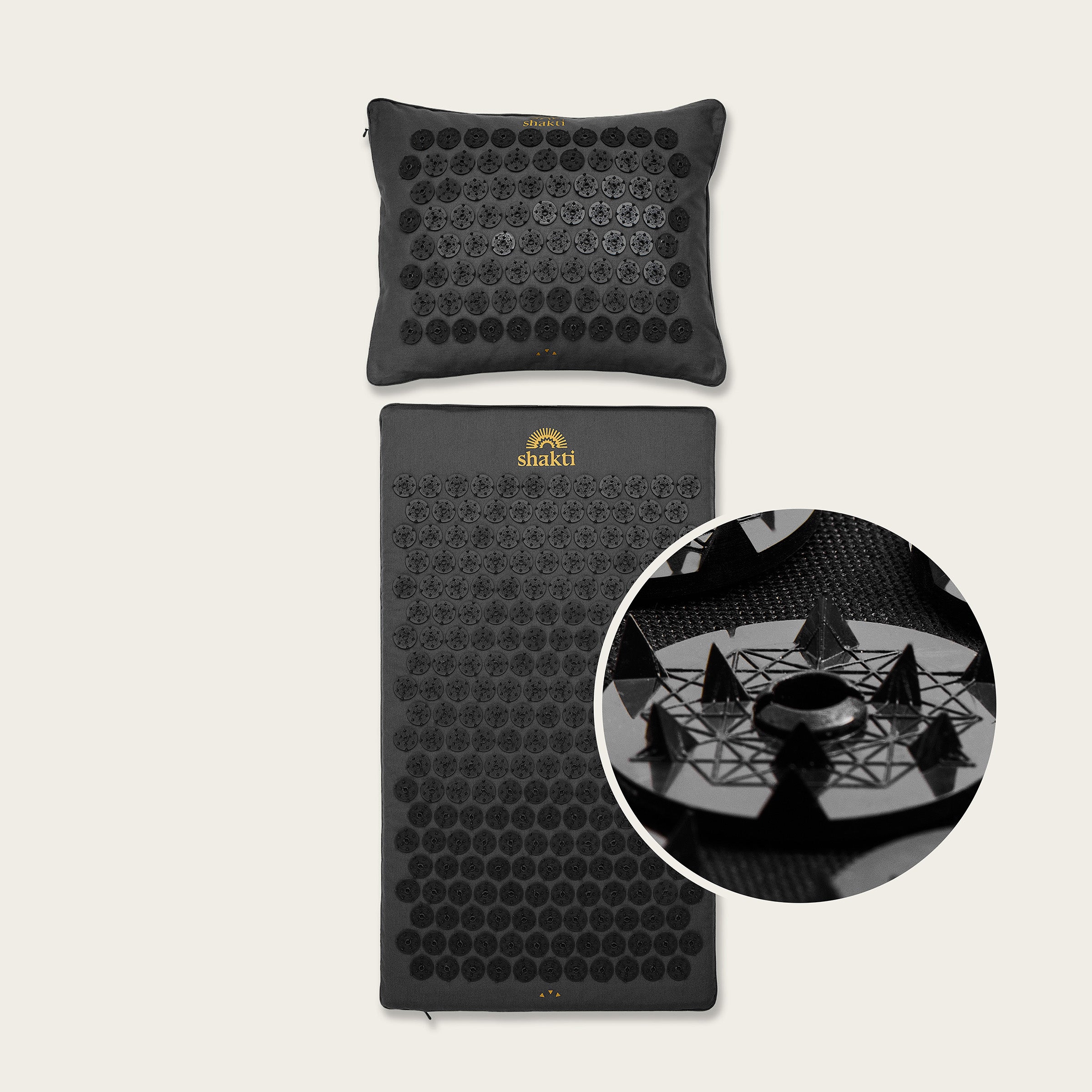 Black acupressure mat and pillow set with 'Shakti' branding on a beige background.